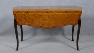 A 19th century French style drop flap dining table with foliate inlaid top on cabriole supports. H.