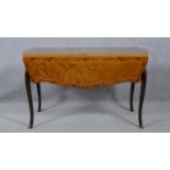 A 19th century French style drop flap dining table with foliate inlaid top on cabriole supports. H.