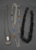 A collection of silver and bakelite necklaces. Including a graduated bakelite link necklace (no