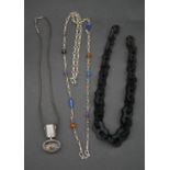 A collection of silver and bakelite necklaces. Including a graduated bakelite link necklace (no