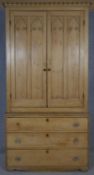 A 19th century pine kitchen pantry cabinet with shaped dentil cornice above Gothic arched panelled