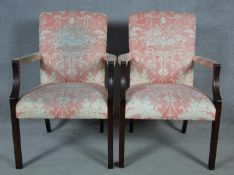 A pair of Georgian style mahogany framed open armchairs in blush floral upholstery. H.95 W.65 D.60cm