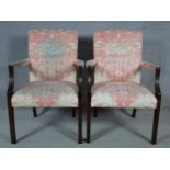 A pair of Georgian style mahogany framed open armchairs in blush floral upholstery. H.95 W.65 D.60cm