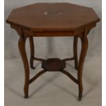 An Edwardian mahogany and satinwood strung occasional table with central floral inlay on cabriole