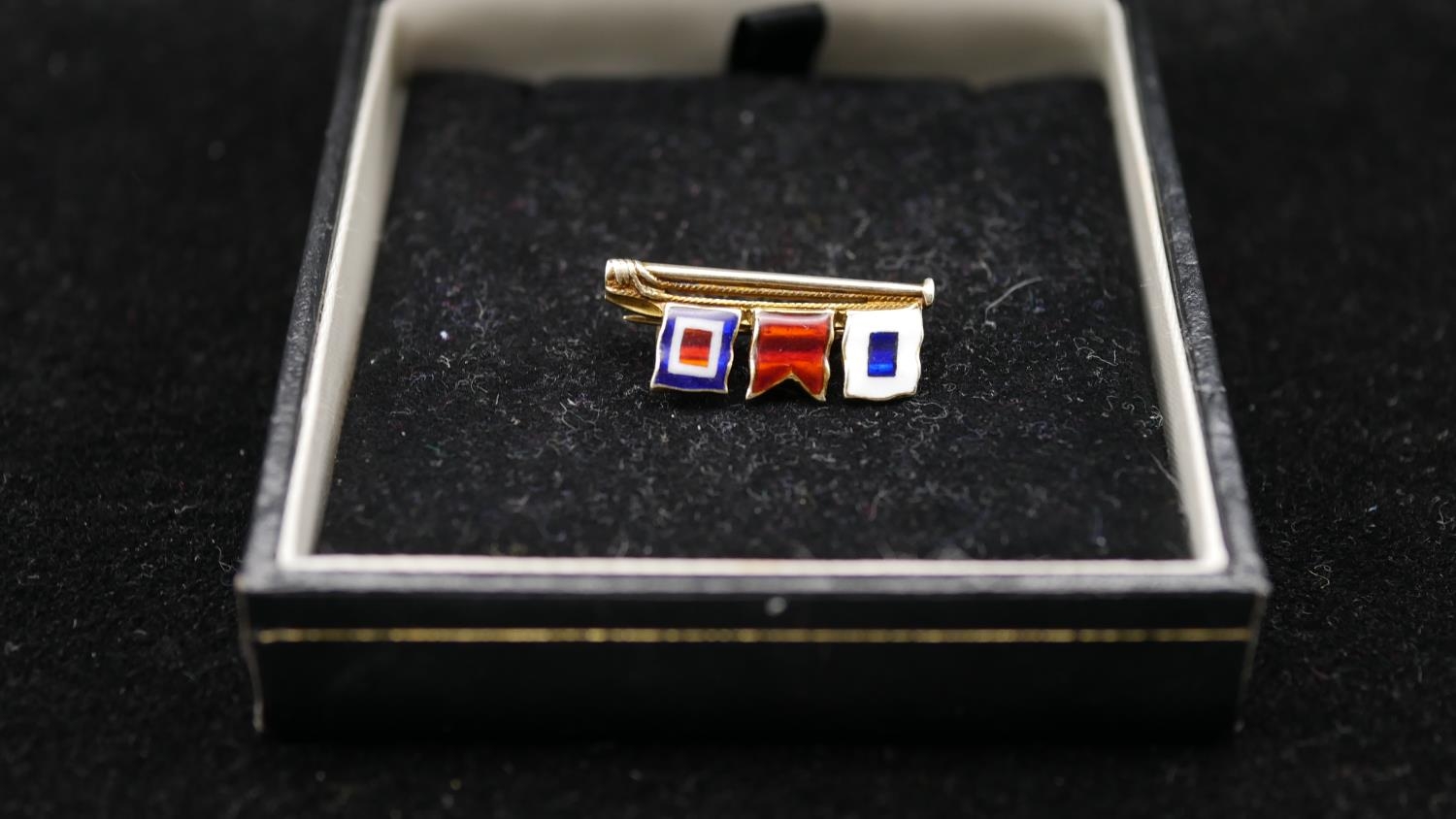 A 9ct signal flag sweetheart brooch, spells SBW, each flag enamelled. Hallmarked JWB, Birmingham,