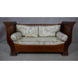 An Empire style mahogany day bed with Toile de Jouy upholstered fitted cushions. Converts to child's