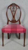 A 19th century mahogany dining chair with carved swag and ribbon detail to the back raised on square