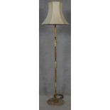 A mid century vintage onyx and brass standard lamp on circular platform base.173cm