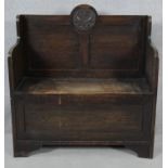 An early 20th century country antique style oak hall bench with hinged lidded seat and coffer