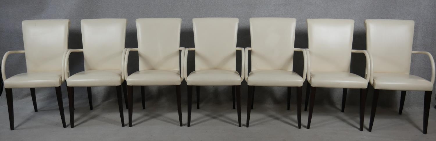 A set of seven contemporary Poltrona Frau Vittoria model dining armchairs in leather upholstery on
