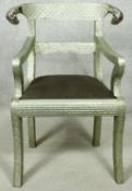 A Regency style embossed metal armchair with ram's head rail back above drop in seat on sabre