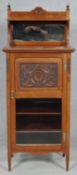 A late Victorian walnut music cabinet with bevelled glass superstructure above carved panel door