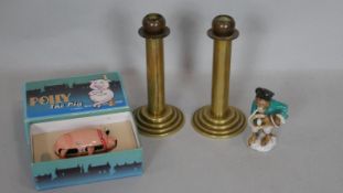 A pair of vintage brass candlesticks on stepped bases, a vintage boxed clockwork toy and a ceramic