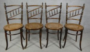 A set of four late 19th century Continental beech framed bentwood cafe style dining chairs with rail