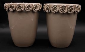 A pair of contemporary ceramic glazed vases with sculpted roses around the rim. H.25cm