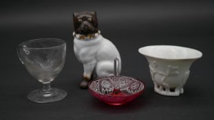 A collection of antique glass and ceramics. Including a porcelain bulldog, an engraved posset glass,