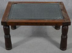 An Indian hardwood occasional table with plate glass on a metal lattice work inset top. H.38 L.68.