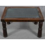 An Indian hardwood occasional table with plate glass on a metal lattice work inset top. H.38 L.68.