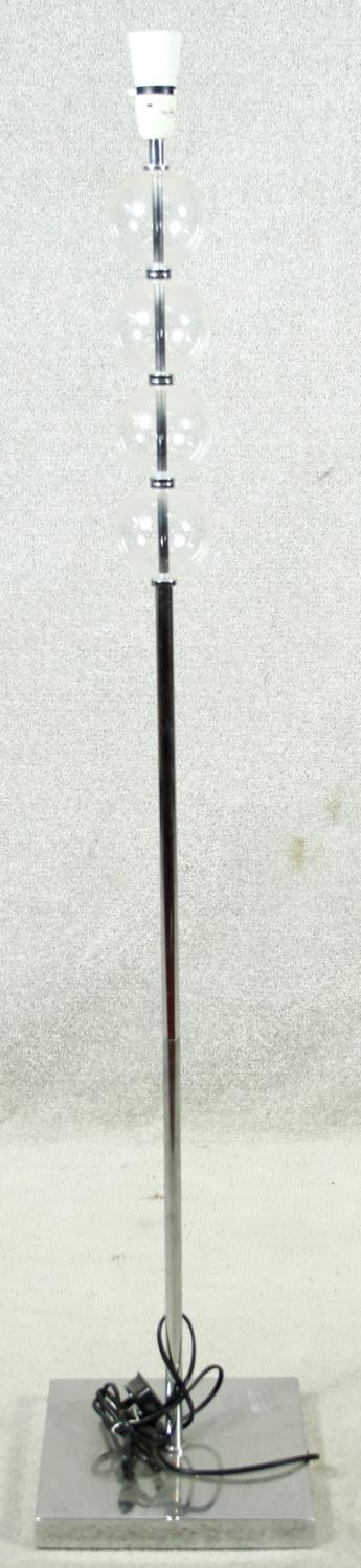 A contemporary chrome and glass standard lamp. H.133cm