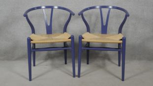 A pair of Carl Hansen and Sons wishbone chairs by Hans J Wegner with label to underside. H.76cm