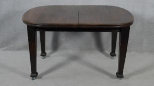 A late 19th century oak extending dining table with wind out mechanism and extra leaf. H.73 L.178