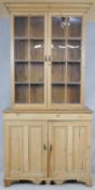 A 19th century pitch pine two section bookcase or pantry cupboard with upper glazed section above