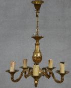 A six branch brass chandelier with scrolling foliate arms. D.40cm