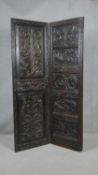 An antique oak single fold screen with a pair of foliate and mask carved panels. H.180 W.56cm (