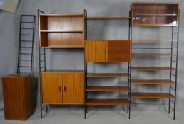 A large mid century teak Ladderax bookcase and shelving system. H.199 W.330cm.