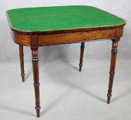 A 19th century mahogany fold over top card table on turned tapering supports. H.73 W.91 D.45cm