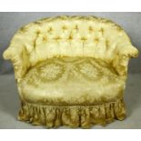 A 19th century two seater tub sofa in deep buttoned damask upholstery on turned tapering supports.