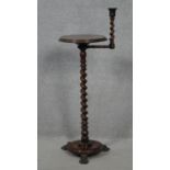 A 19th century mahogany night stand with swing action barley twist candlestick and pedestal