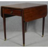 A Georgian mahogany drop flap Pembroke table fitted with a pair of end drawers raised on square