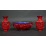 A Chinese carved cinnabar lacquer bowl with blue enamel interior and a pair of similar vases. Dia.