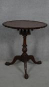 A Georgian style mahogany occasional table with piecrust tilt top and birdcage action on carved