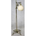 A vintage steel lamp with rise and fall action and adjustable glass globe shade. H.96cm