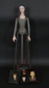 A carved and painted folk art standing figure of a medieval style woman and four similar framed
