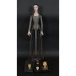 A carved and painted folk art standing figure of a medieval style woman and four similar framed