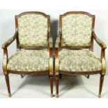 A pair of Louis XVI style carved walnut armchairs with gilt highlighting in floral upholstery raised