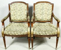 A pair of Louis XVI style carved walnut armchairs with gilt highlighting in floral upholstery raised