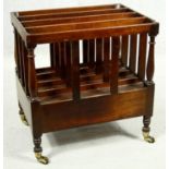 A 19th century style mahogany Canterbury fitted with magazine sections and a base drawer on turned