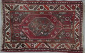 A Heriz rug with double pole central medallions in a stylised multi border. L.148 W.104cm