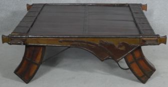 An Eastern hardwood metal bound coffee table on shaped swept supports. H.36 L.103 W.98cm