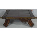 An Eastern hardwood metal bound coffee table on shaped swept supports. H.36 L.103 W.98cm