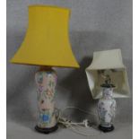 A Chinese style baluster form table lamp on hardwood base and a similar lamp. H.75cm (One in need of