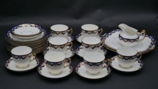 A Paragon porcelain tea service in blue and white with gilt highlights with maker's mark to the