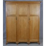 A C.1900 light oak fitted wardrobe with hanging section and fitted with linen slides and drawers