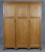 A C.1900 light oak fitted wardrobe with hanging section and fitted with linen slides and drawers