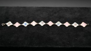 A Danish silver and guilloche enamel link bracelet. Alternating links in pink and white with various