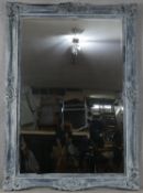 A large wall mirror with bevelled plate in distressed Rococo style frame. H.216 W.154cm